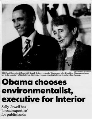 Newspaper clipping shows a smiling man in a suit and a woman at a podium in front of the American flag. Headline text says Obama chooses environmentalist, executive for interior. Sally Jewell has broad expertise for public lands.